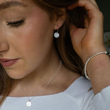BIRTH MONTH FLOWER HOOP EARRING IN STERLING SILVER  