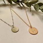 Engraved Forget Me Not necklace showing sterling silver and gold filled floral bouquet pendants
