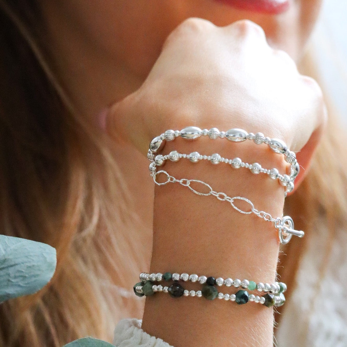 Girl wearing sterling silver bracelet stack
