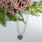 Sterling silver necklace chain with a poppy birth month flower.