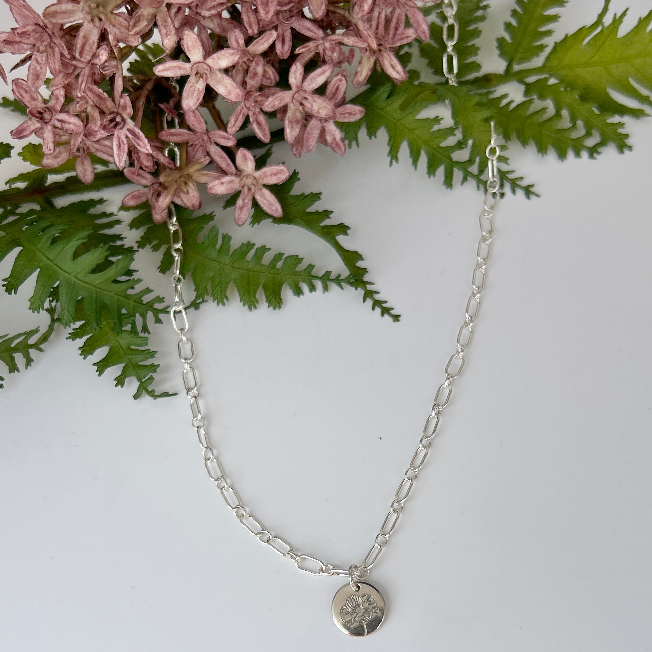 Sterling silver botanical necklace chain with birth flower pendant.