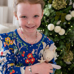 Young girl wearing her Liberty birthstone necklace and liberty bracelet