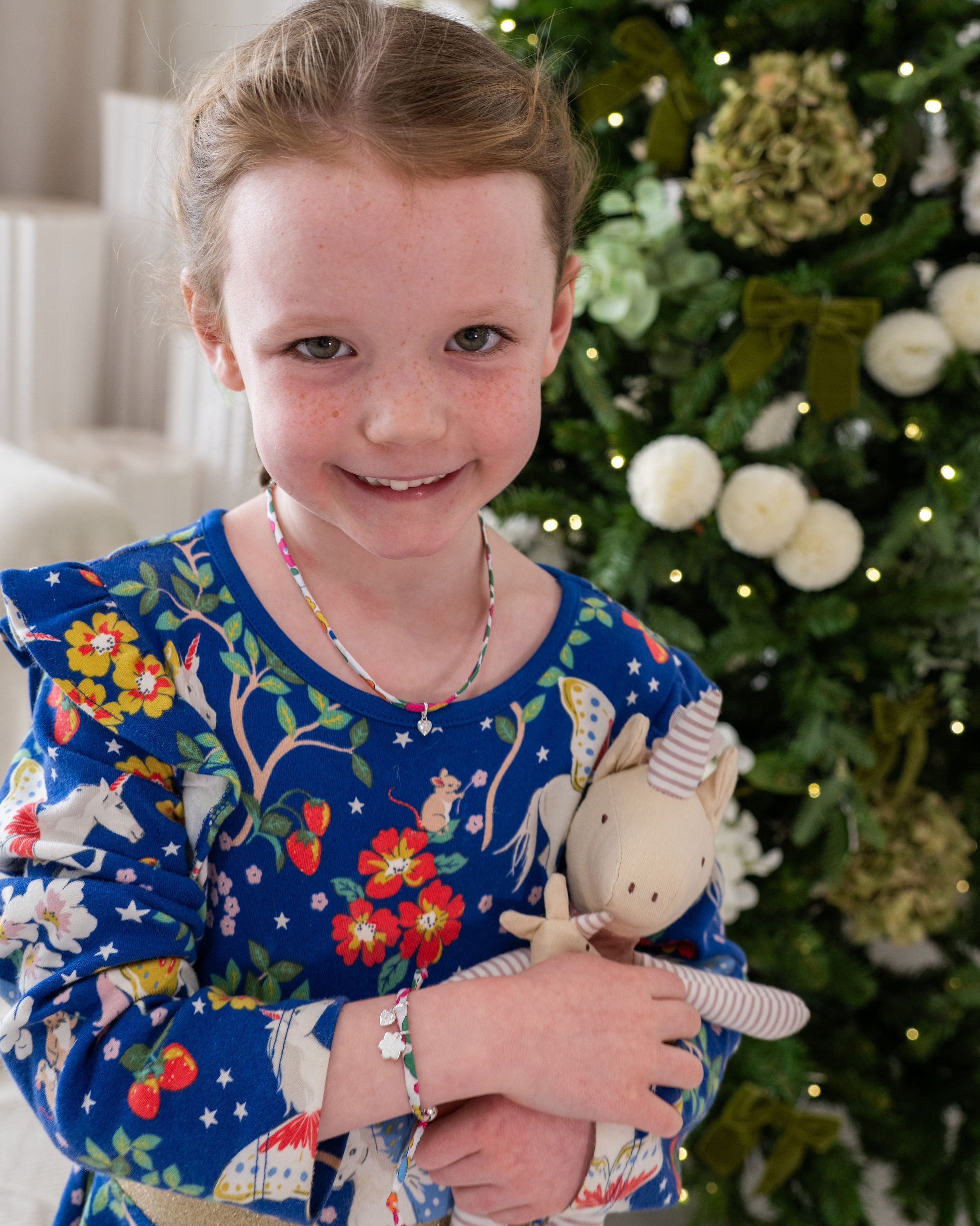 Young girl wearing her Liberty birthstone necklace and liberty bracelet