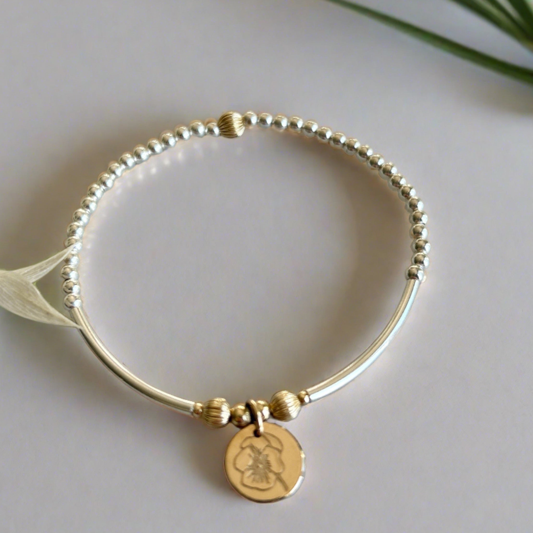 Beaded bracelet made with sterling silver and gold filled with a birth month flower 