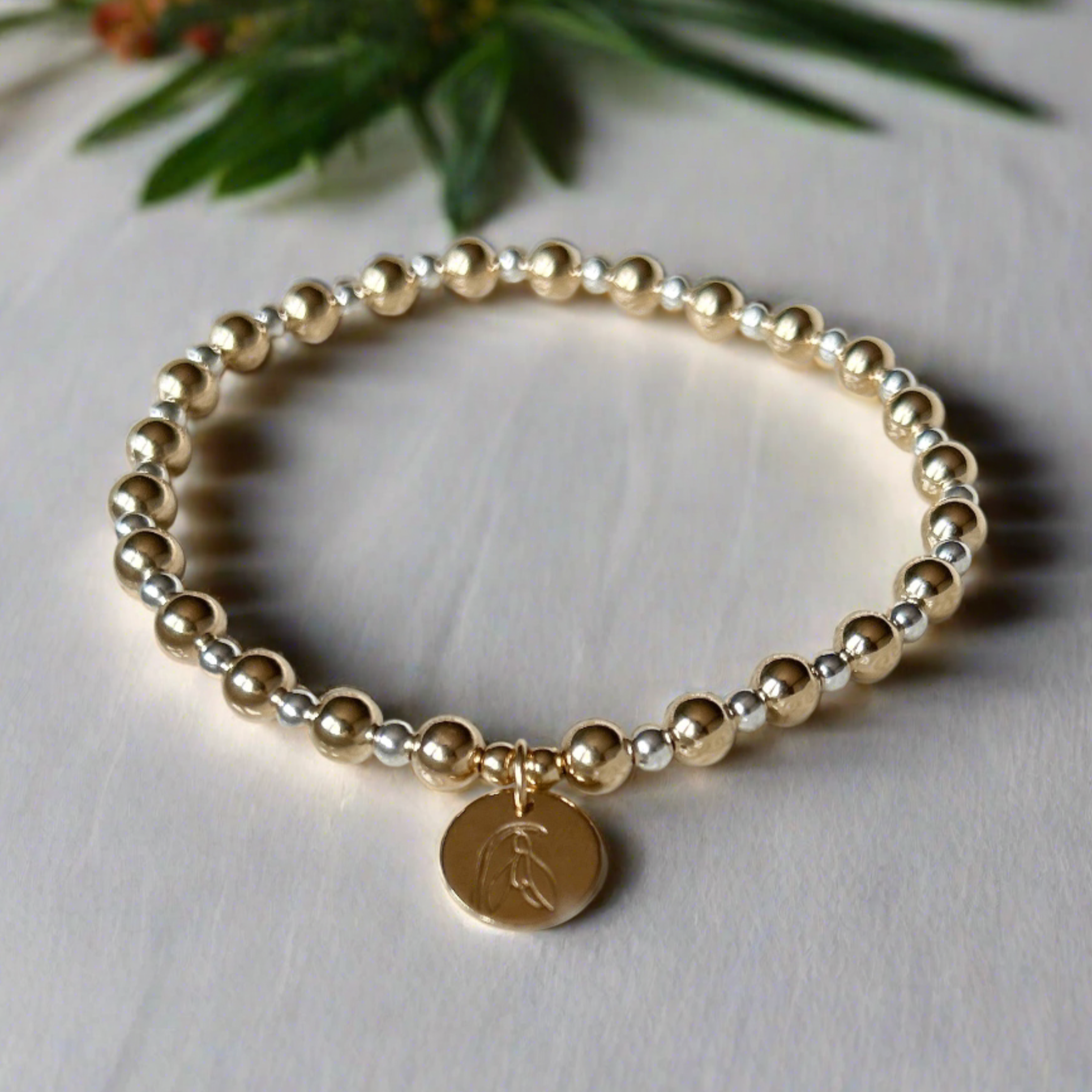 Mix metal birth flower bracelet with gold filled and sterling silver beads and birth flower pendant